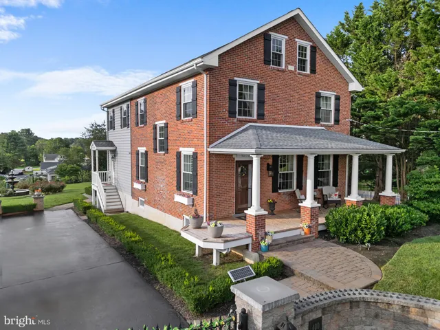 a view of a house with a yard patio and fire pit