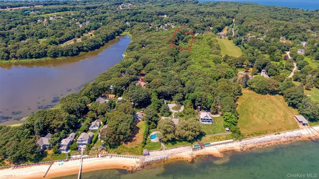 an aerial view of a house with a yard and outdoor seating