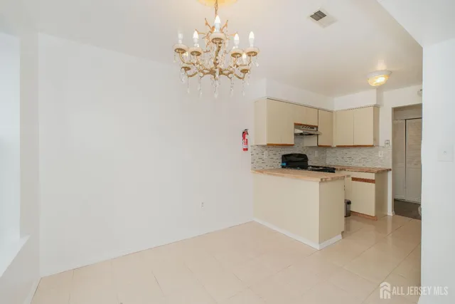 a kitchen with a white cabinets and window