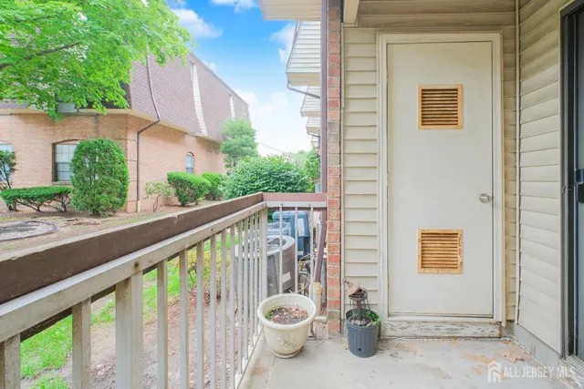 a view of a balcony with chair and potted plants
