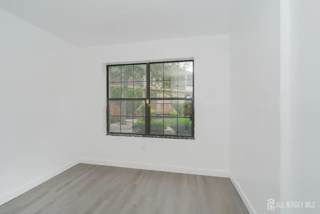 a bathroom with a granite countertop sink toilet and mirror