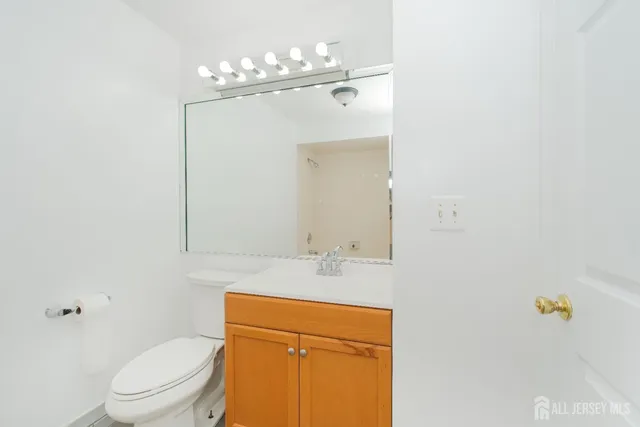 a white toilet sitting next to a bath tub