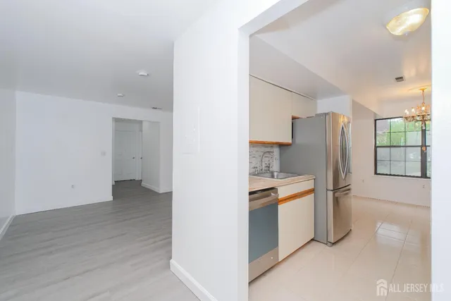 a kitchen with stainless steel appliances a refrigerator and a stove