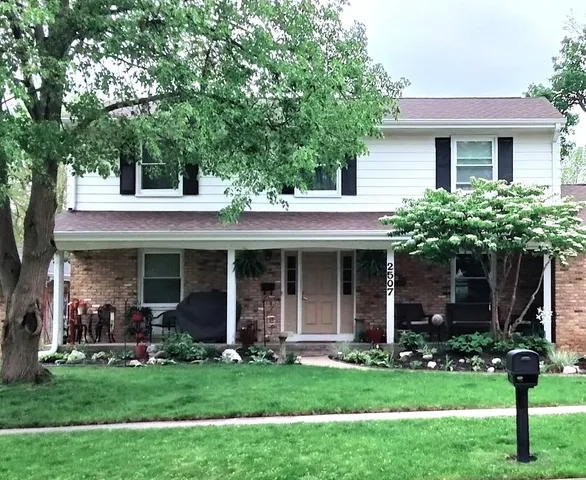 a view of a house with a yard and plants