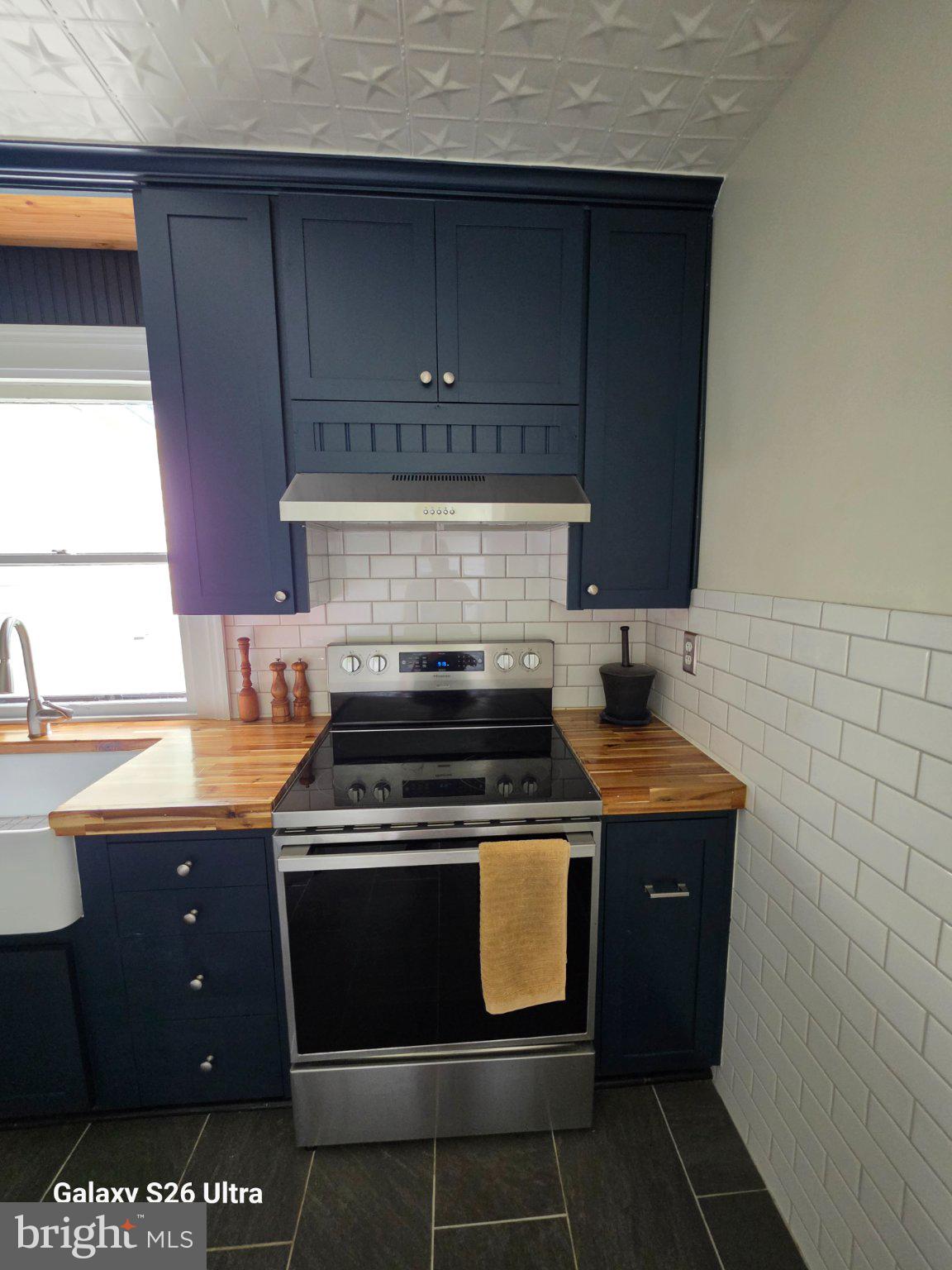 22729 Rapidan Road Mitchells, VA 22729 - Photo 7 of 39 Chic kitchen with navy cabinetry.