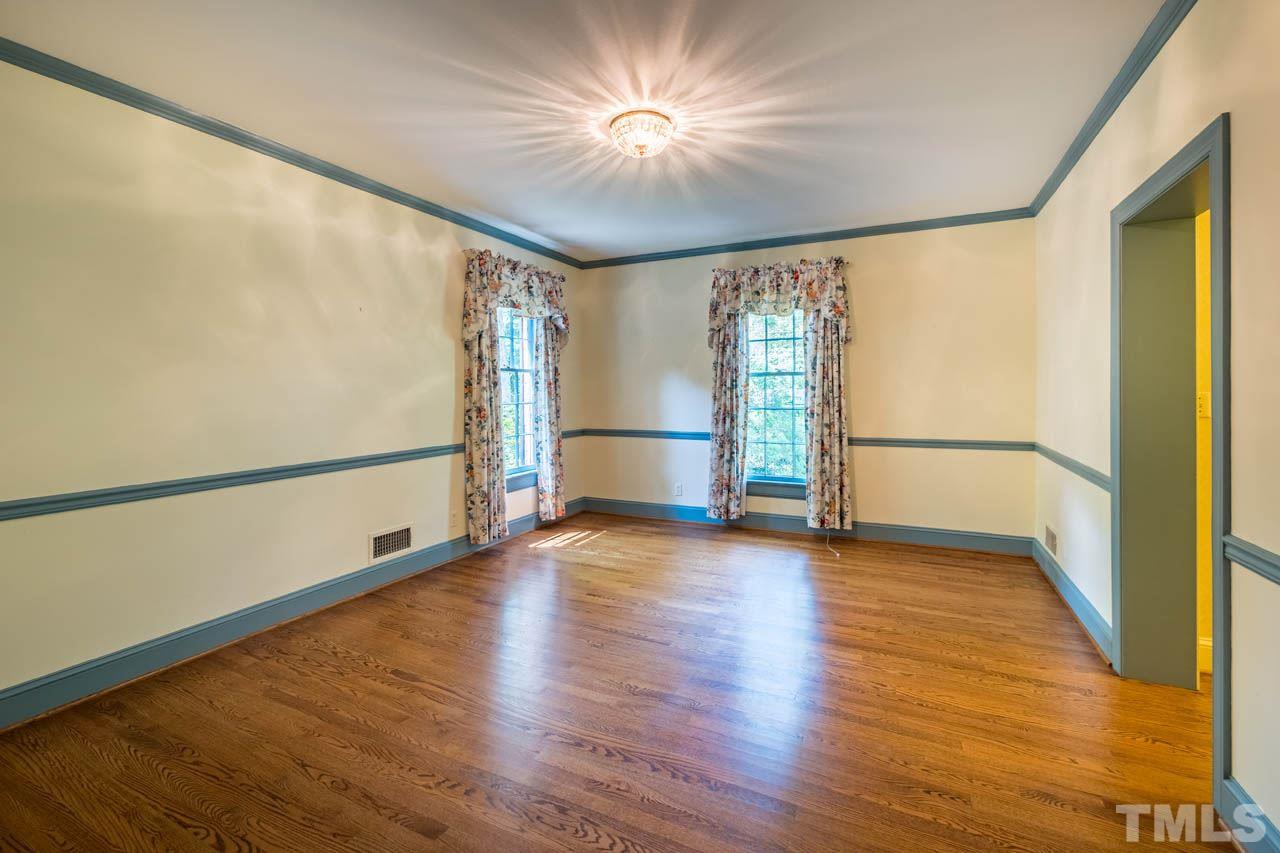 3210 Sussex Road Raleigh, NC 27612 - Photo 24 of 29 a view of empty room with wooden floor and fan