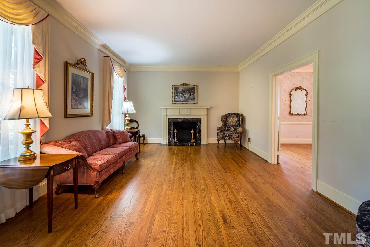 3210 Sussex Road Raleigh, NC 27612 - Photo 6 of 29 a living room with furniture and a fireplace