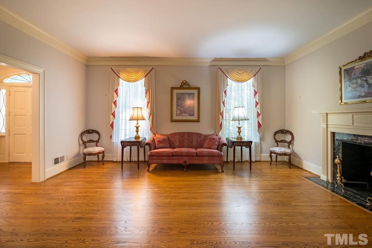 3210 Sussex Road Raleigh, NC 27612 - Photo 7 of 29 a living room with furniture and a fireplace