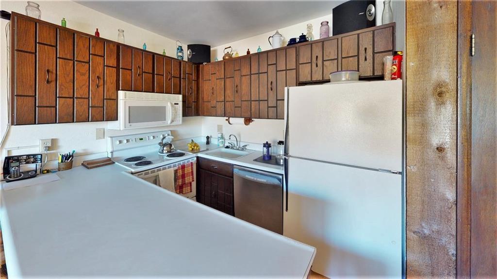 170 Evergreen Road, Unit 305 Dillon, CO 80435 - Photo 12 of 22 a kitchen with a refrigerator a stove a sink a washer and dryer