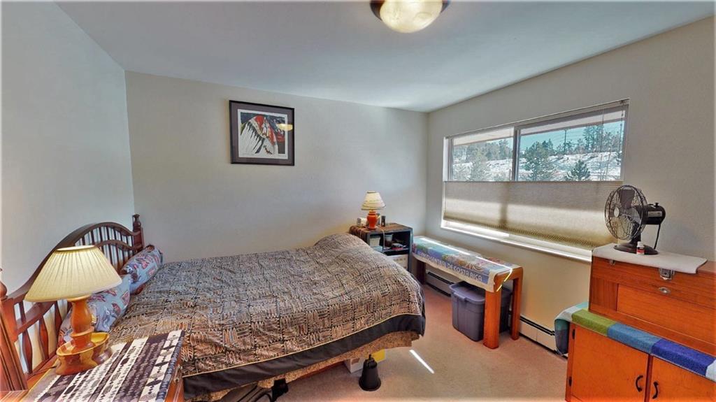 170 Evergreen Road, Unit 305 Dillon, CO 80435 - Photo 14 of 22 a bedroom with a bed and window
