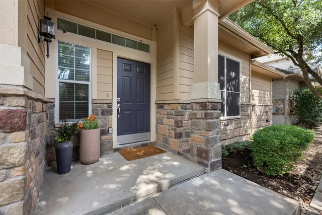 a view of a brick house with potted plants