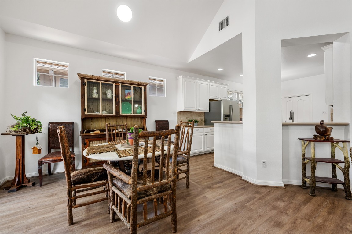 11000 Anderson Mill Road, Unit 63 Austin, TX 78750 - Photo 11 of 40 a view of a dining room with furniture and wooden floor