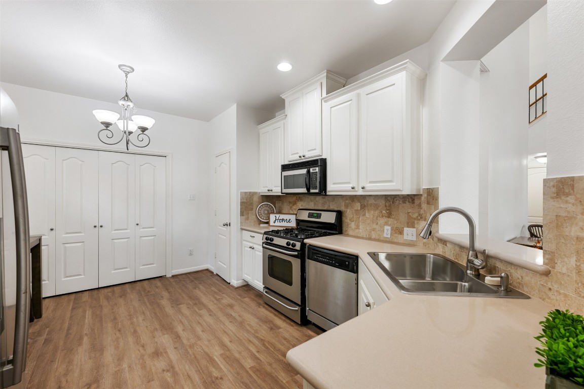 11000 Anderson Mill Road, Unit 63 Austin, TX 78750 - Photo 18 of 40 a kitchen with granite countertop a sink stainless steel appliances and cabinets