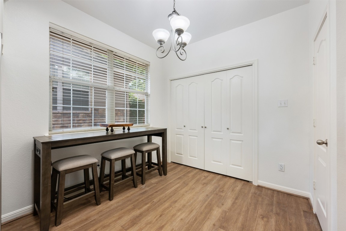 11000 Anderson Mill Road, Unit 63 Austin, TX 78750 - Photo 20 of 40 a view of a room with wooden floor and windows