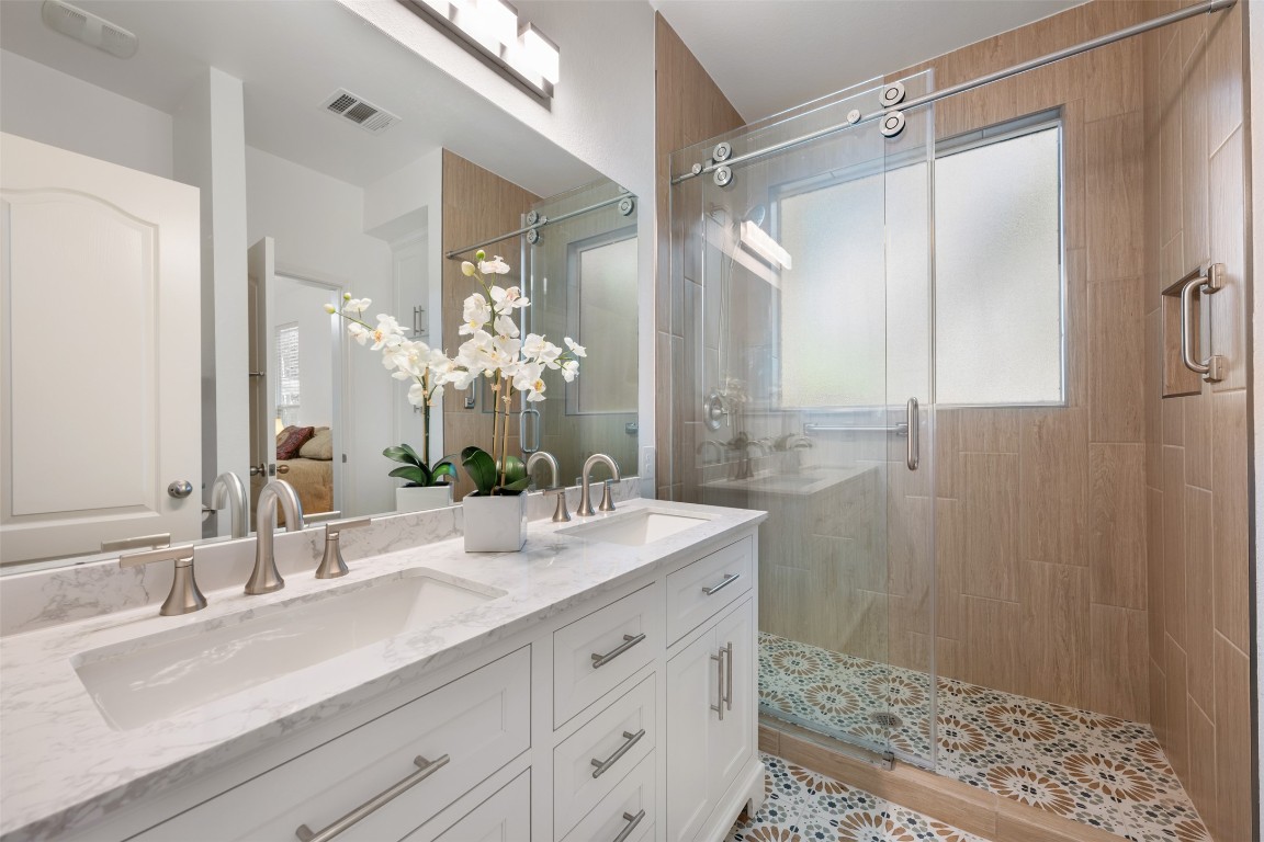 11000 Anderson Mill Road, Unit 63 Austin, TX 78750 - Photo 2 of 40 a bathroom with a double vanity sink mirror and shower