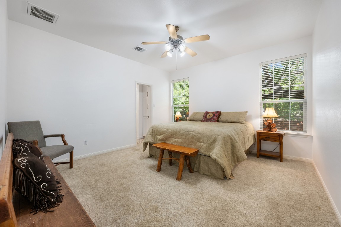 11000 Anderson Mill Road, Unit 63 Austin, TX 78750 - Photo 21 of 40 a spacious bedroom with a bed and a chandelier