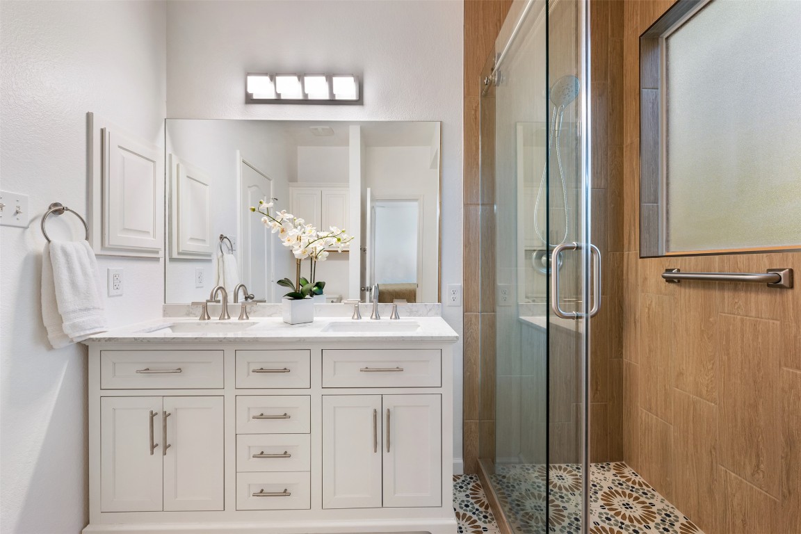 11000 Anderson Mill Road, Unit 63 Austin, TX 78750 - Photo 24 of 40 a bathroom with a double vanity sink and a mirror