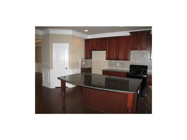 a kitchen with a sink cabinets and a window