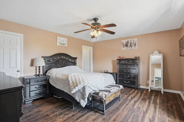 a bedroom with a large bed and a chandelier