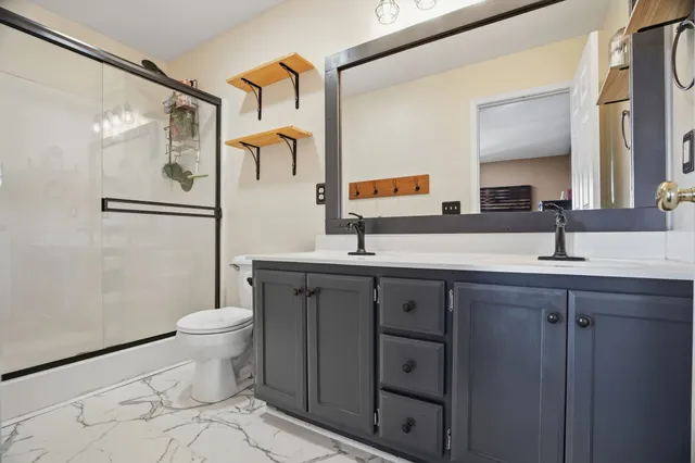 a bathroom with a glass door and a shower