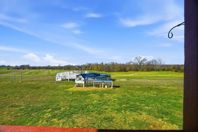 a view of a backyard with table and chairs