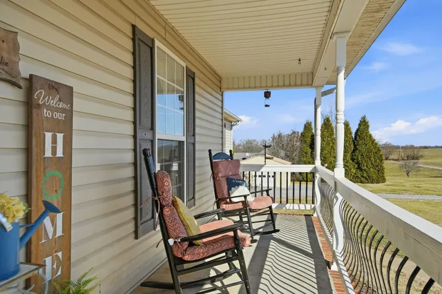 a view of a chairs and table in the balcony