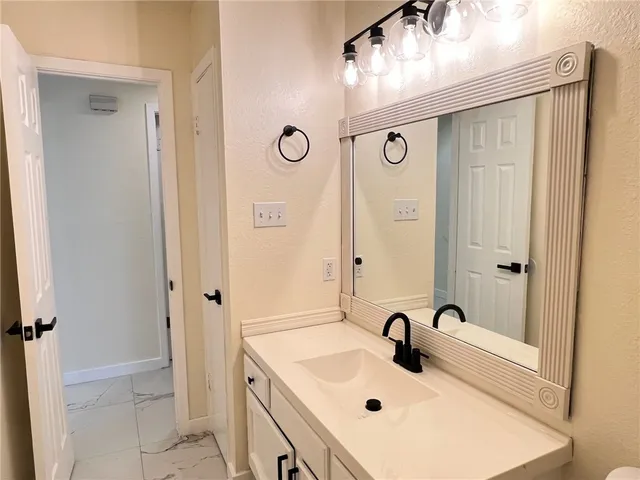 a bathroom with a sink and mirror