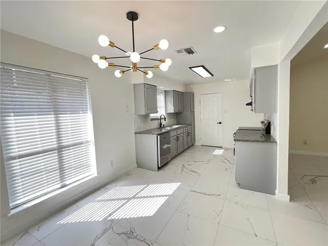a kitchen with a sink and cabinets