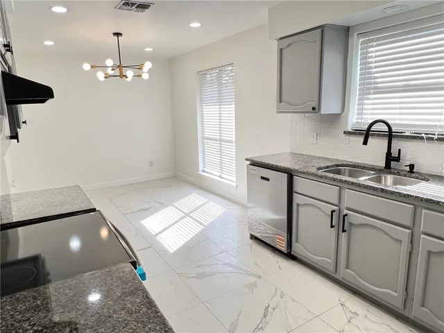 a white house that has tree in front of it