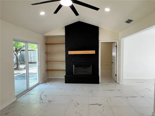 wooden floor in an empty room with a fireplace
