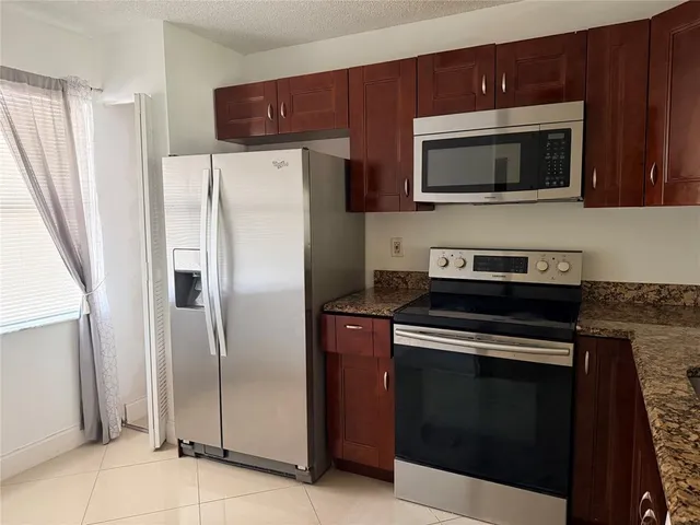 a view of an empty room and a window
