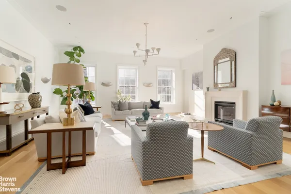 a living room with fireplace furniture and a chandelier
