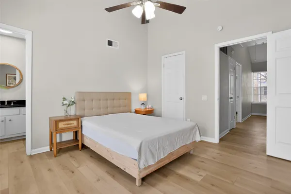 a bedroom with a bed and a chandelier