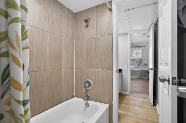 a bathroom with a tub and shower