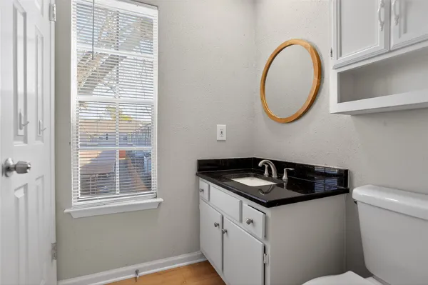 a bathroom with a granite countertop sink and a mirror