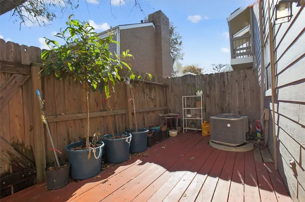 a view of a roof deck with wooden floor and seating space
