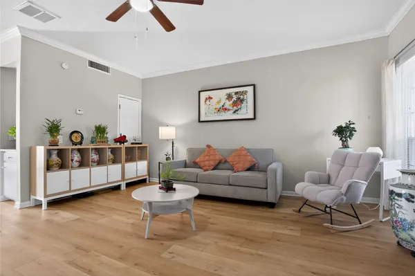 a living room with furniture a rug and a chandelier