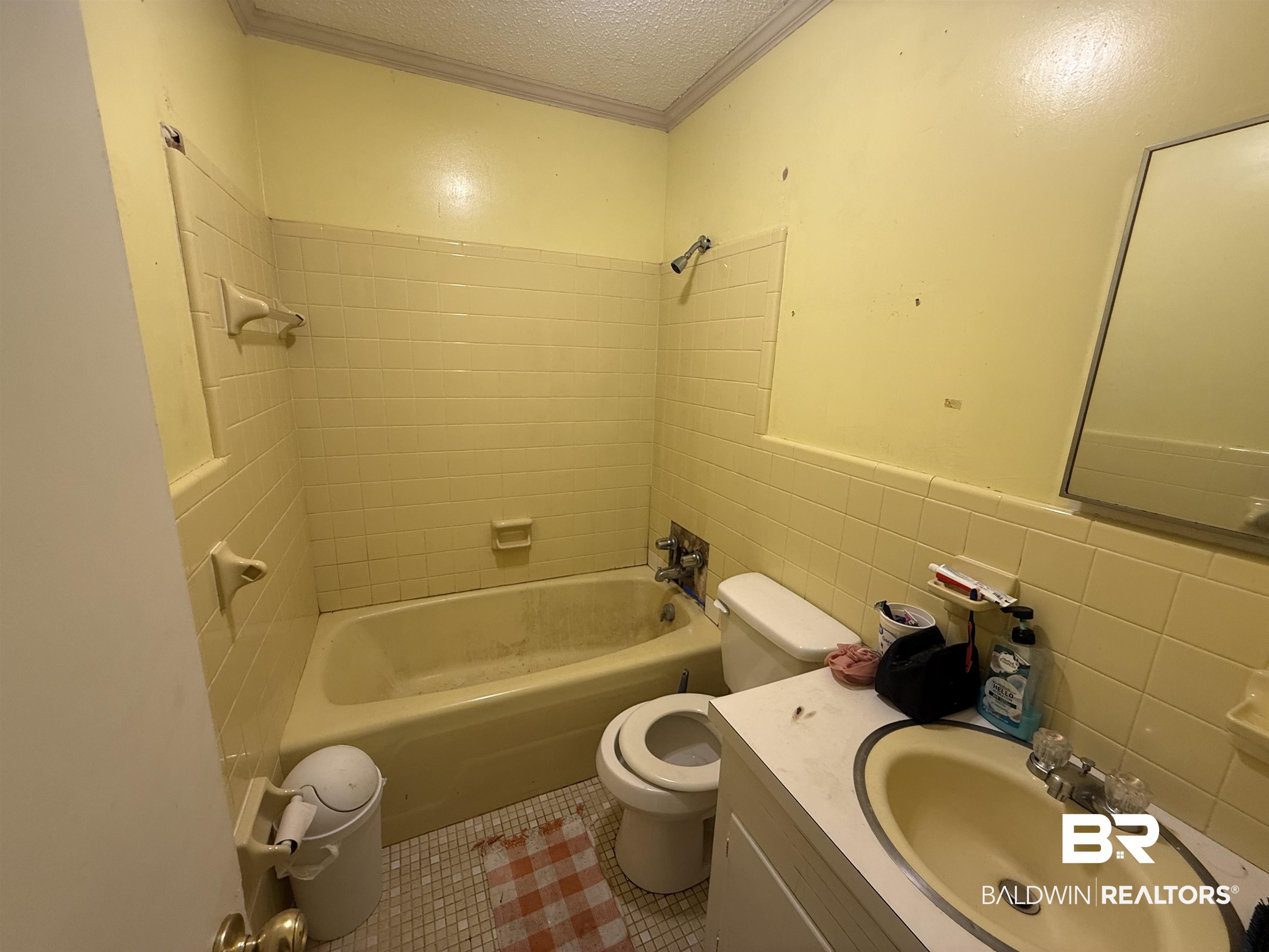 2807 Pea Ridge Road Brewton, AL 36426 - Photo 9 of 12 Full bathroom featuring tile walls, a textured ceiling, vanity, shower / tub combination, and tile patterned floors