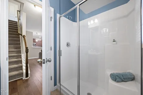 a bathroom with a shower and a glass door
