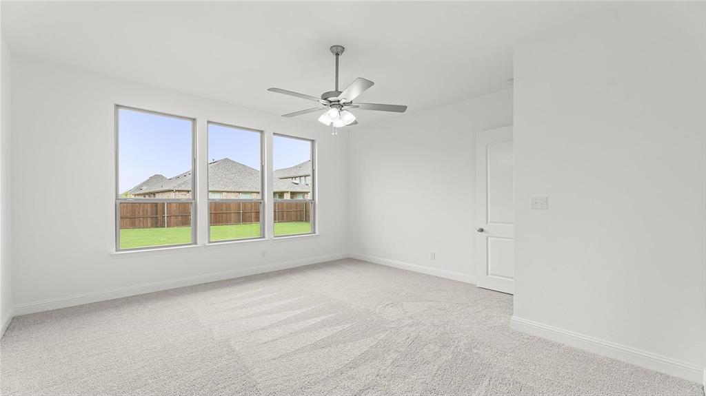 3809 Paradise Way Sherman, TX 75090 - Photo 13 of 16 an empty room with windows and ceiling fan