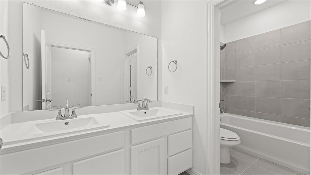 3809 Paradise Way Sherman, TX 75090 - Photo 2 of 16 a bathroom with a double vanity sink toilet and a bathtub