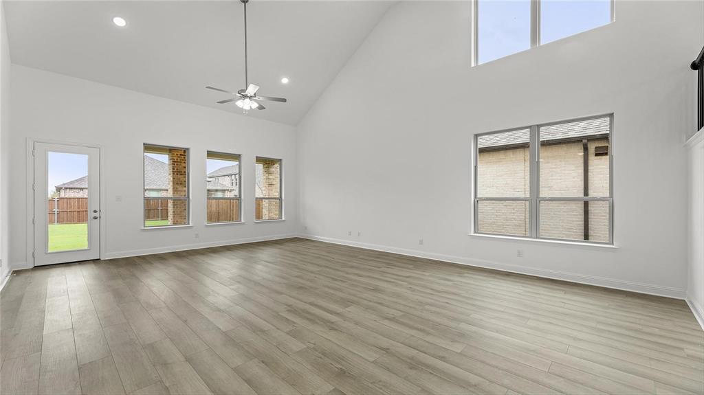 3809 Paradise Way Sherman, TX 75090 - Photo 6 of 16 a view of an empty room with wooden floor and a window