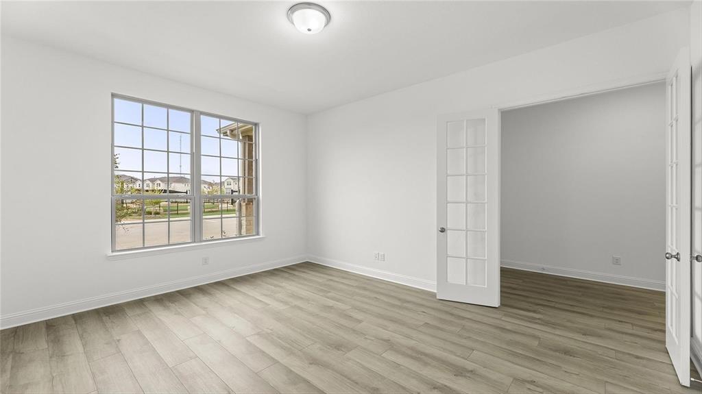 3809 Paradise Way Sherman, TX 75090 - Photo 9 of 16 an empty room with wooden floor and windows