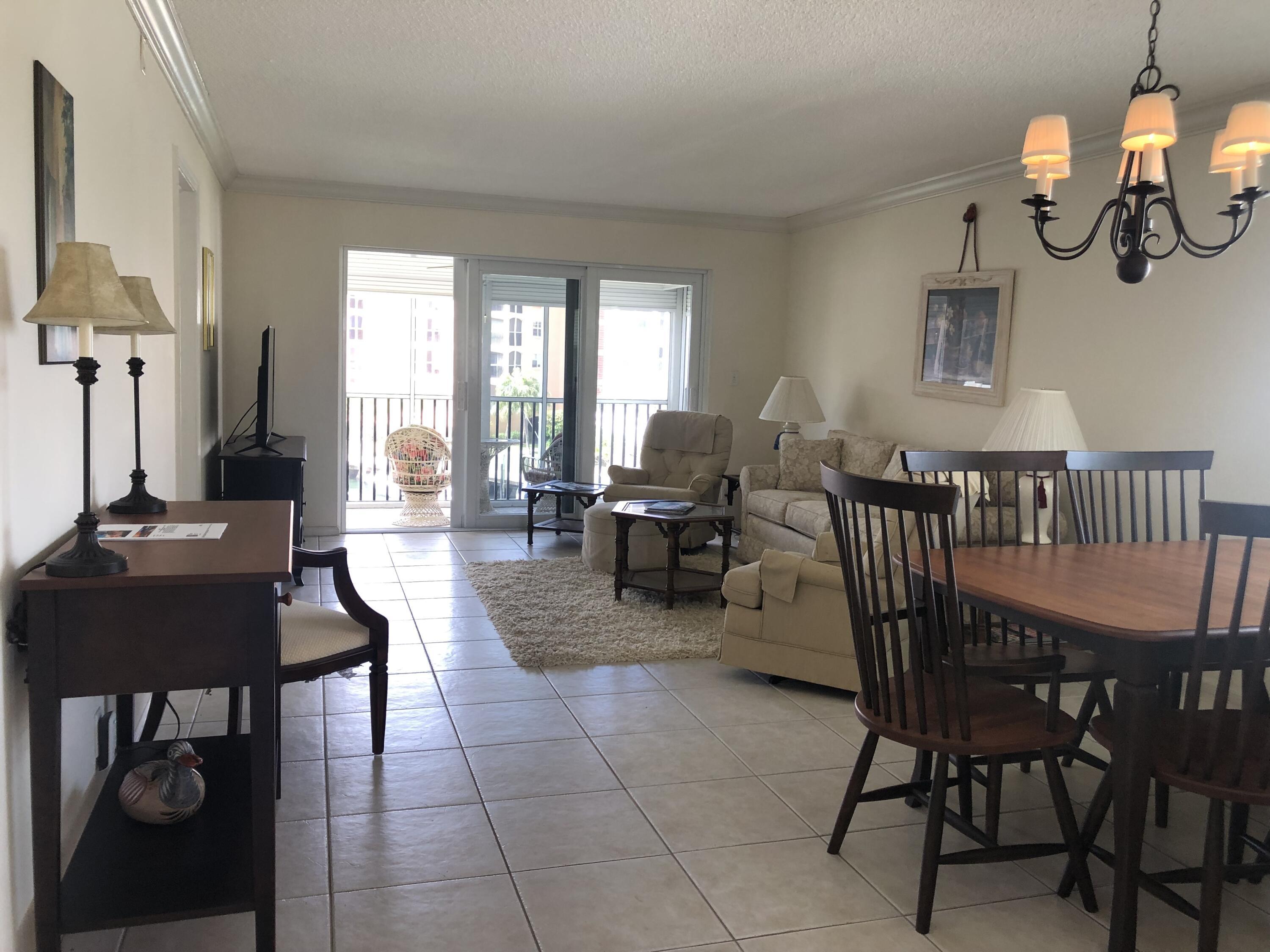 2871 North Ocean Boulevard, Unit M226 Boca Raton, FL 33431 - Photo 18 of 45 a living room with furniture a window and a chandelier