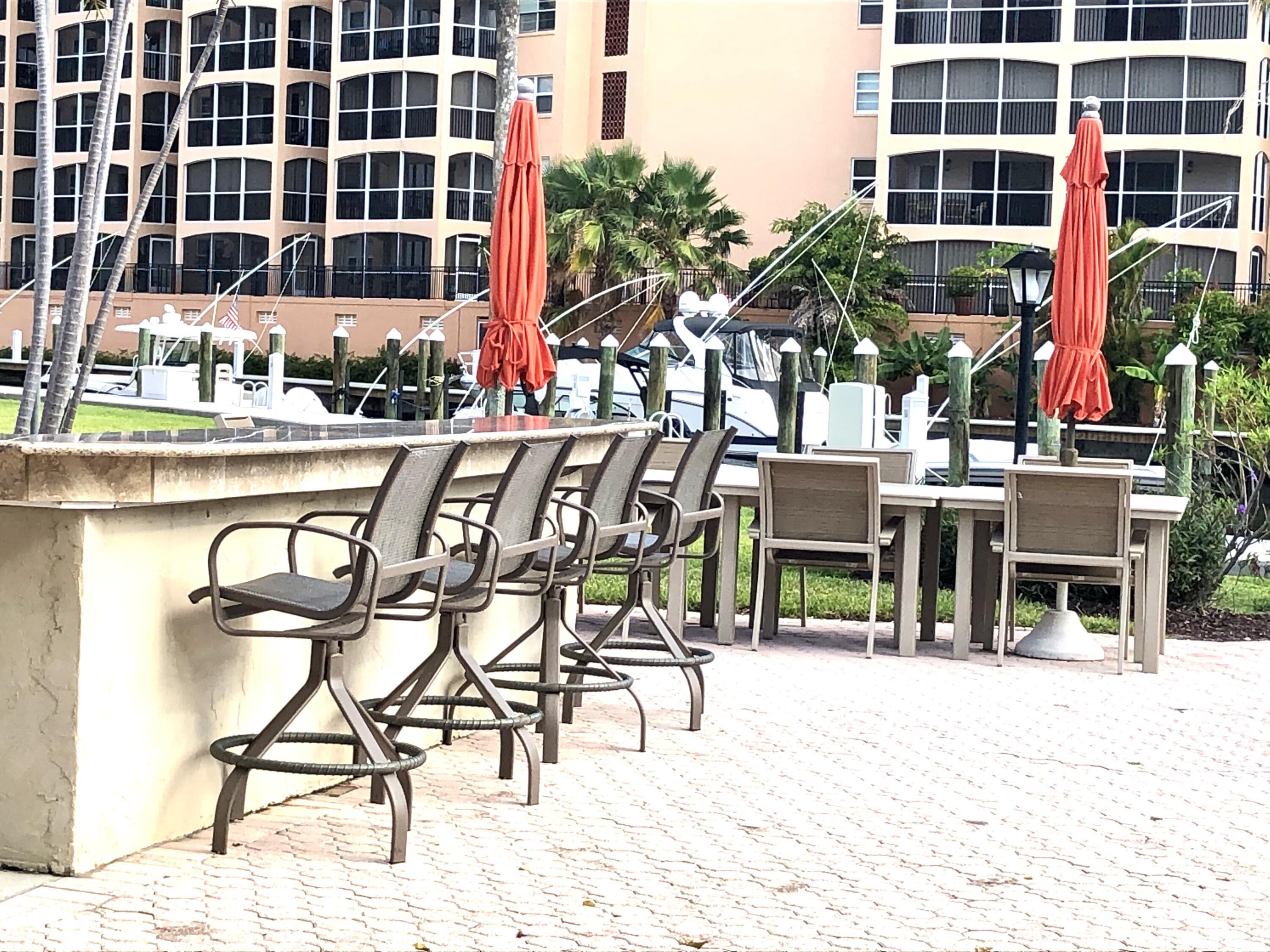 2871 North Ocean Boulevard, Unit M226 Boca Raton, FL 33431 - Photo 24 of 45 a view of a chairs and table in the patio