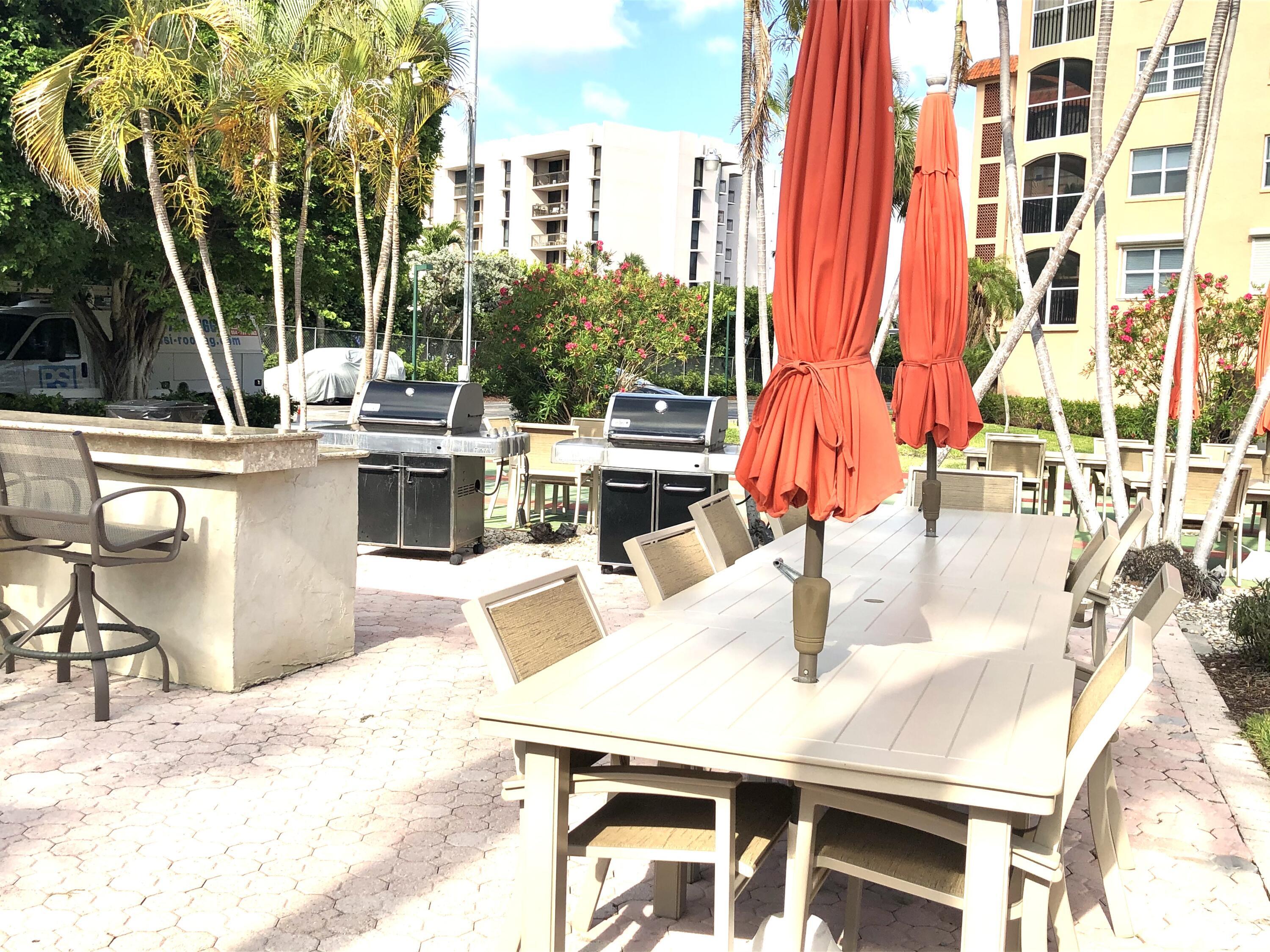 2871 North Ocean Boulevard, Unit M226 Boca Raton, FL 33431 - Photo 25 of 45 a dinning table and chairs in the patio