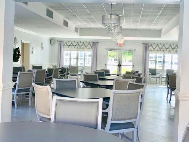 2871 North Ocean Boulevard, Unit M226 Boca Raton, FL 33431 - Photo 27 of 45 a large kitchen with a table and chairs