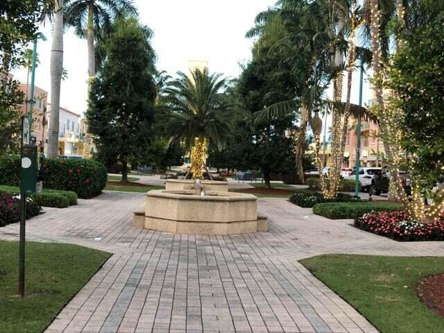 2871 North Ocean Boulevard, Unit M226 Boca Raton, FL 33431 - Photo 38 of 45 a view of a fountain with a bench in the patio