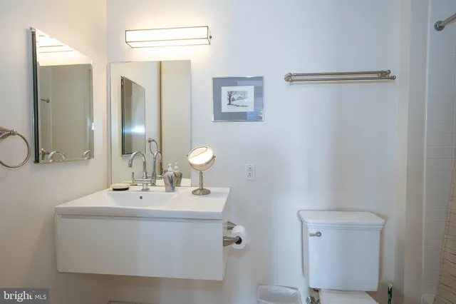 a bathroom with a sink vanity and a mirror