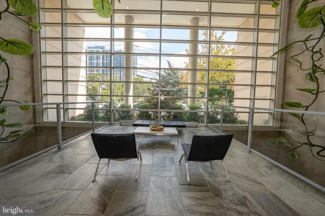 a view of a dining room with a table and chairs